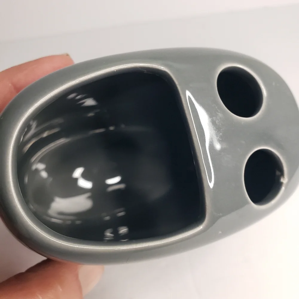 Ceramic toothbrush and toothpaste holder. 171